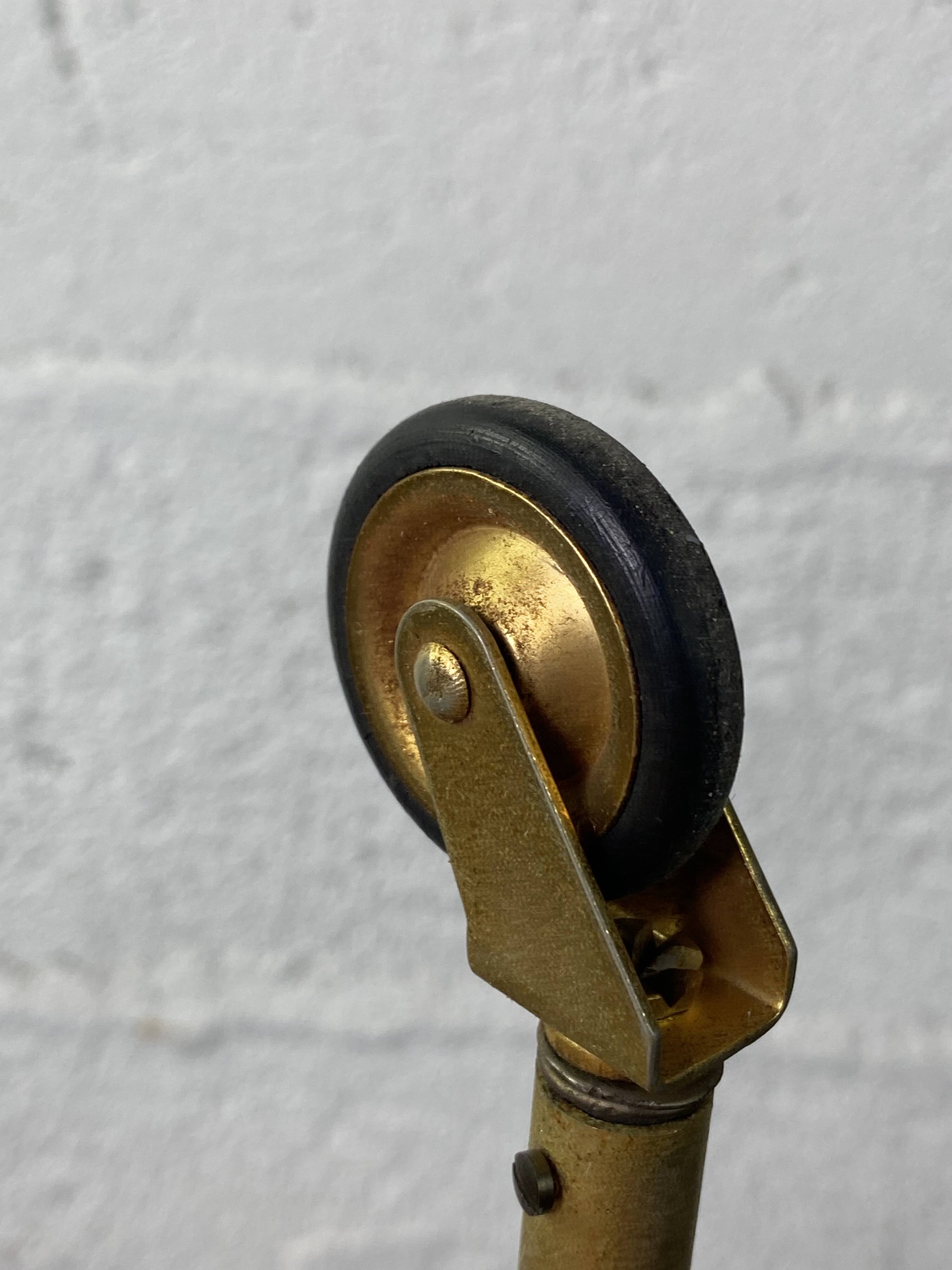Small rolling trolley in brass and black plastic