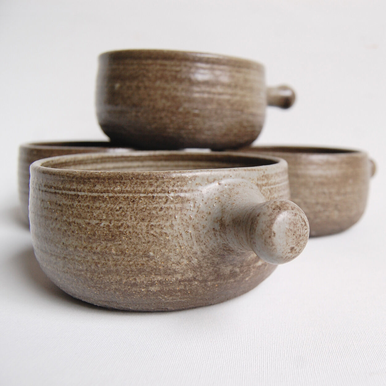 Set of 4 bowls and 4 plates by Thèrèse Bataille for the workshop of Dour 1970s