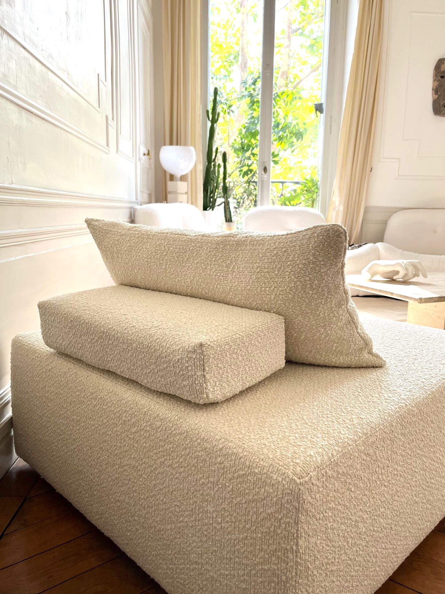 Square ottoman and its cushions in buckle fabric