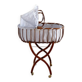 Vintage rattan cradle and its wheeled support