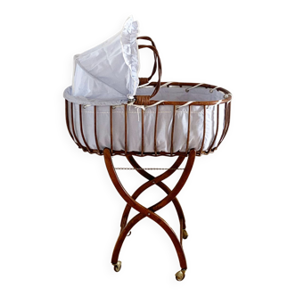 Vintage rattan cradle and its wheeled support
