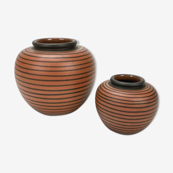 Duo of elchinger ball vases with asymmetrical black stripes background auburn background