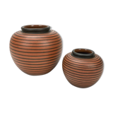 Pair of Elchinger ball vases with asymmetrical black stripes on an auburn background