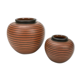 Duo of elchinger ball vases with asymmetrical black stripes background auburn background