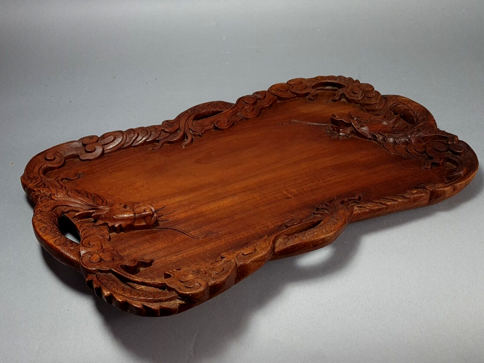 Ancient wooden tray carved with Chinese dragons around 1900