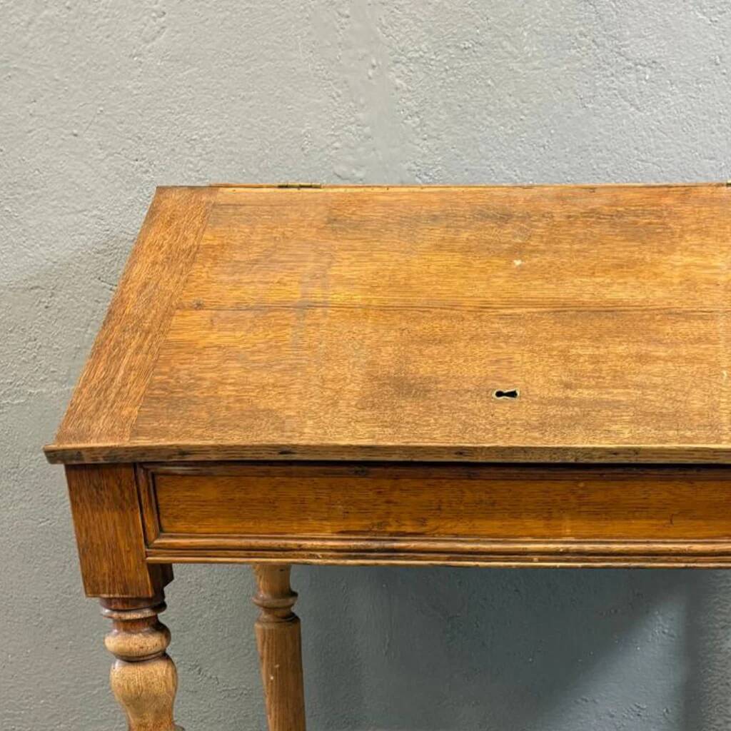 Vintage wooden writing desk with drawer, turned legs, classic style.