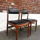 Set of 2 vintage Scandinavian chairs in wood and black faux leather.