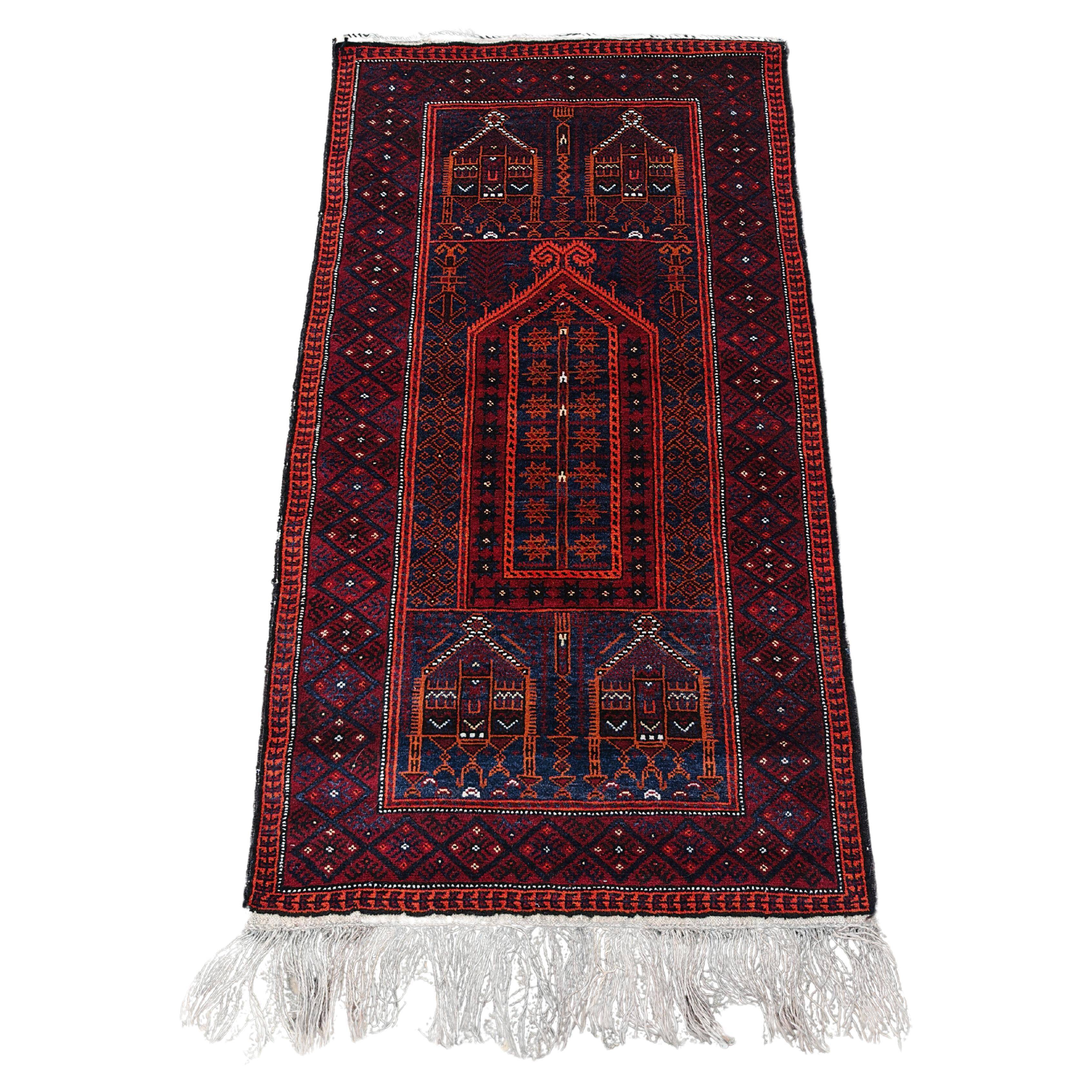 Vintage hand-knotted Persian Baluch prayer rug from the 1940s.