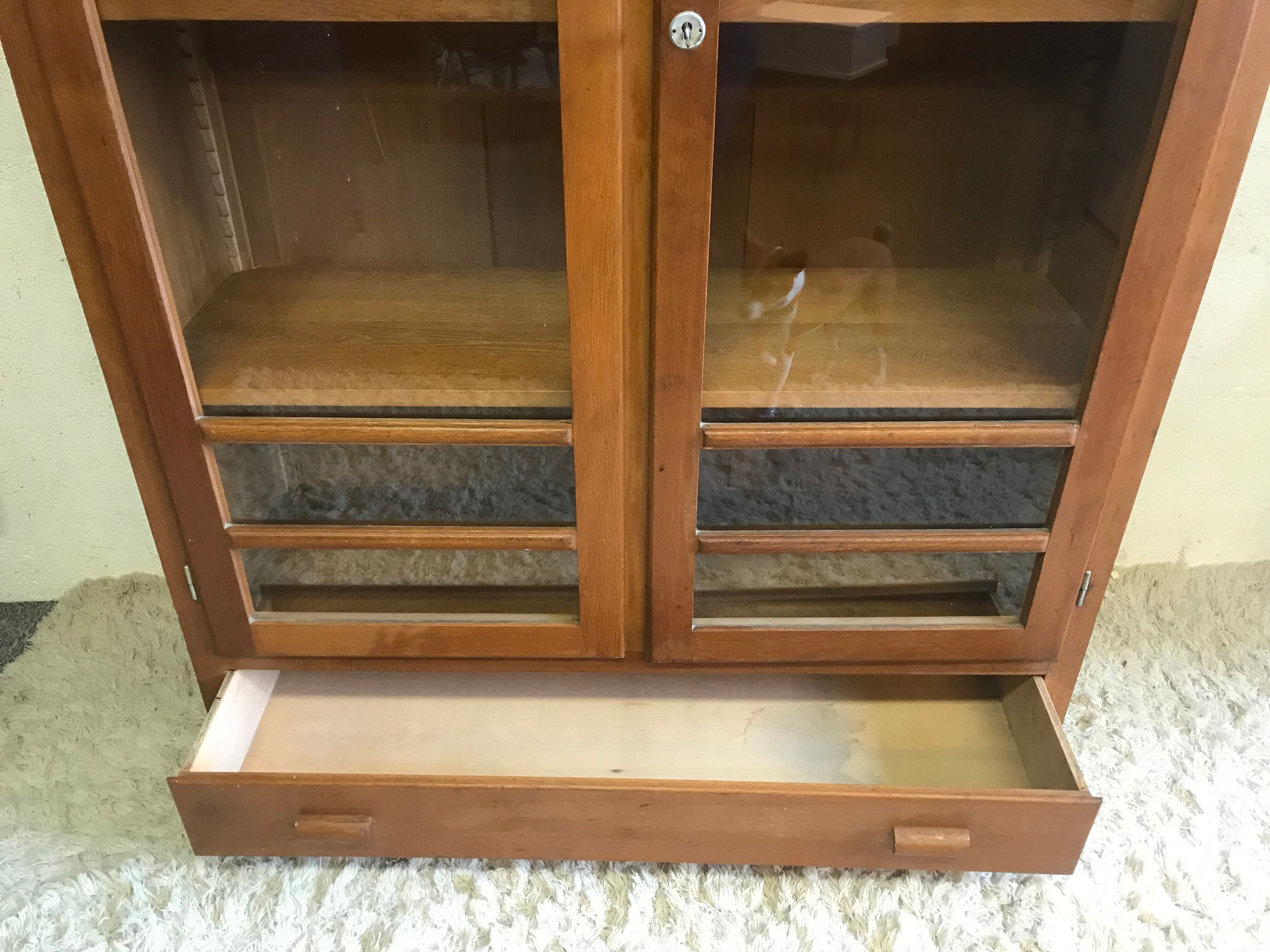 Old school glass bookcase in blond wood