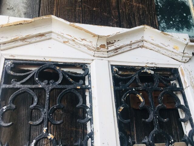 Old door with wrought iron grille