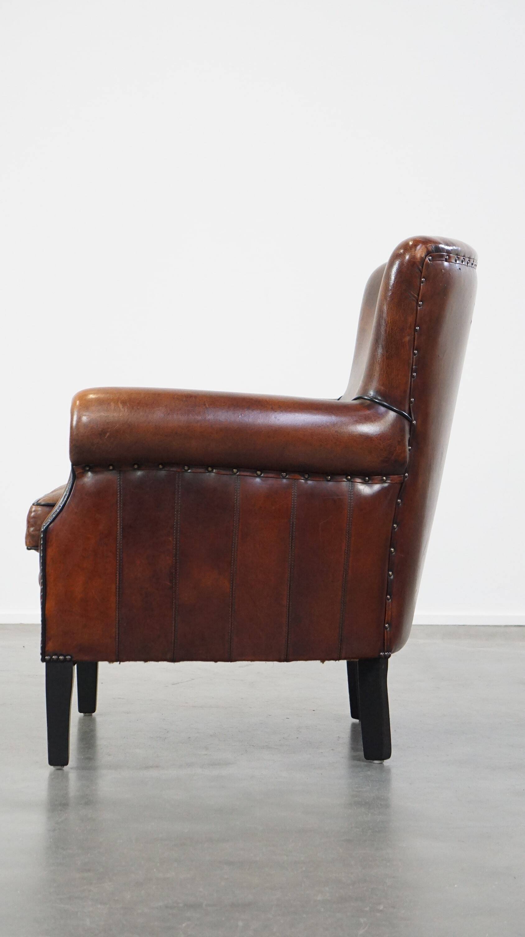 Sheepskin armchair/lounge chair finished with decorative nailheads