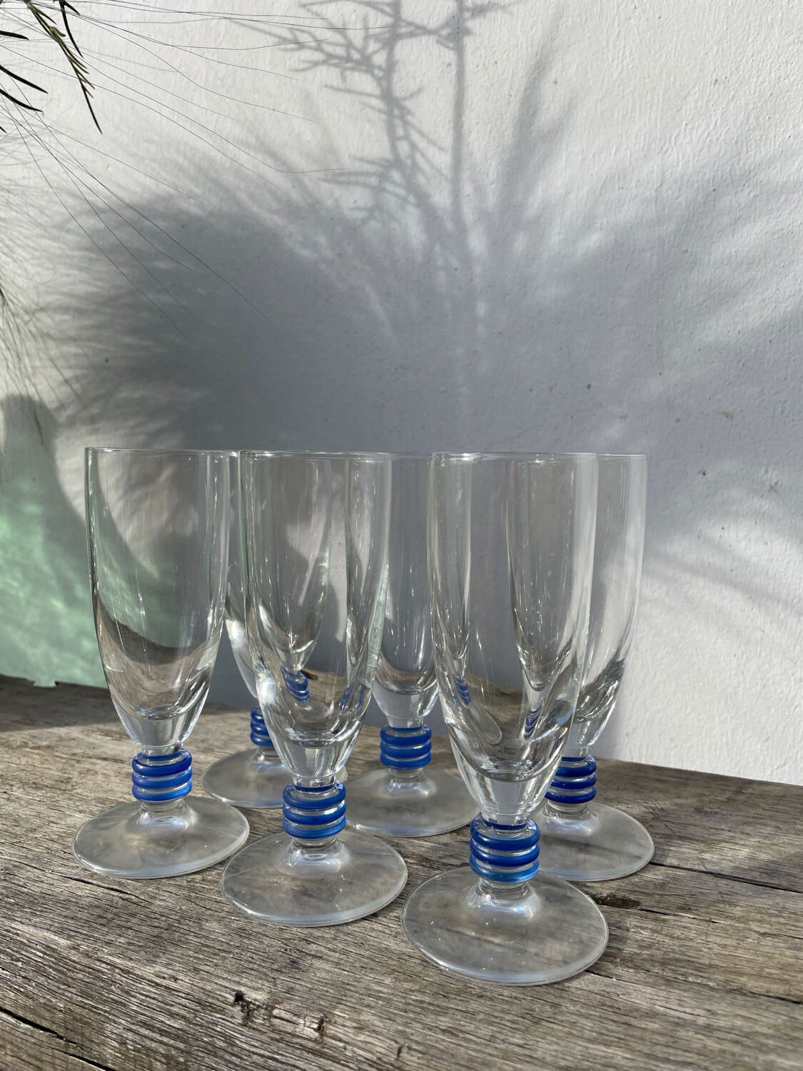 6 clear champagne flutes with blue stems, designer style