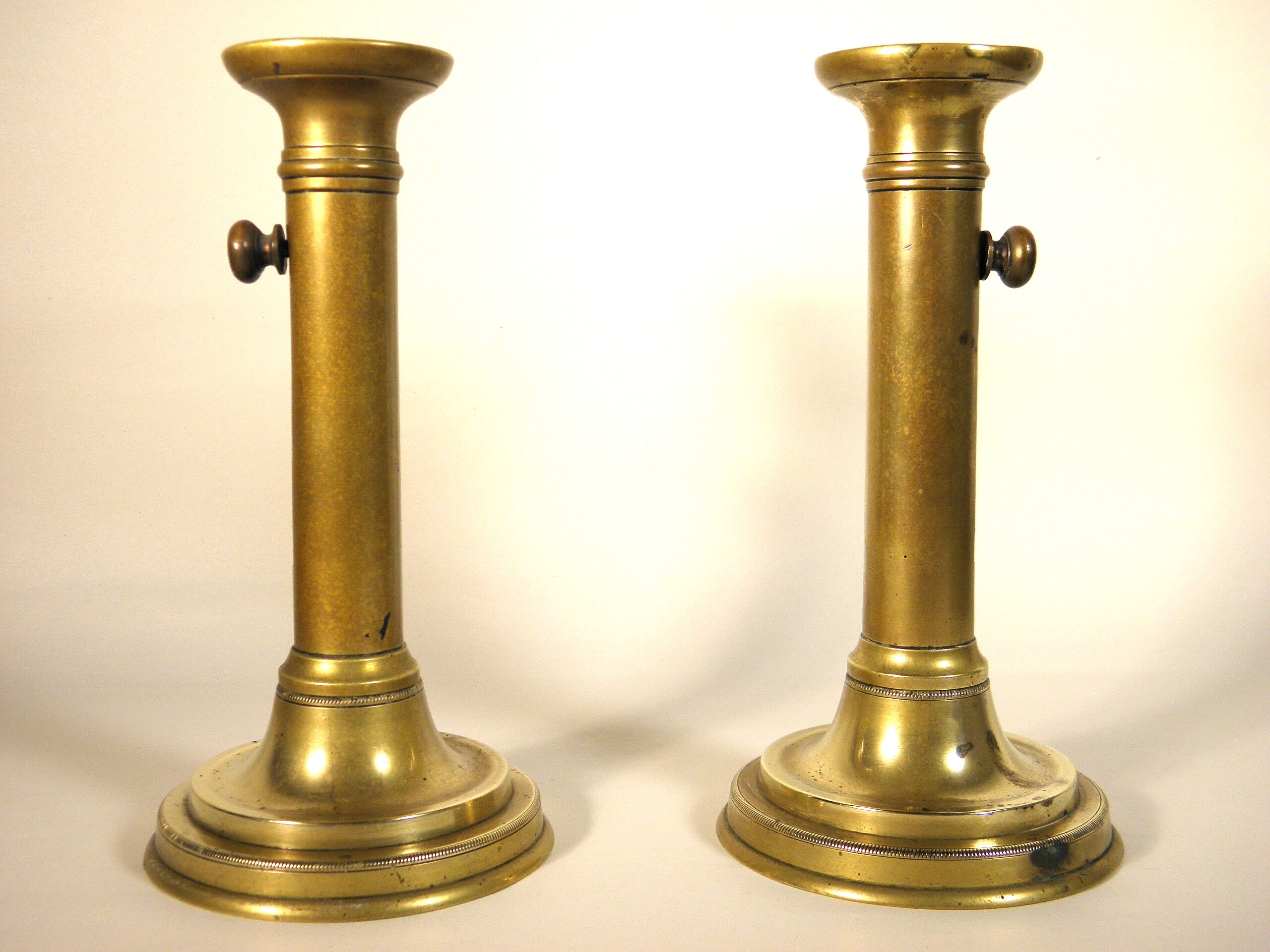 Pair of brass push candlesticks