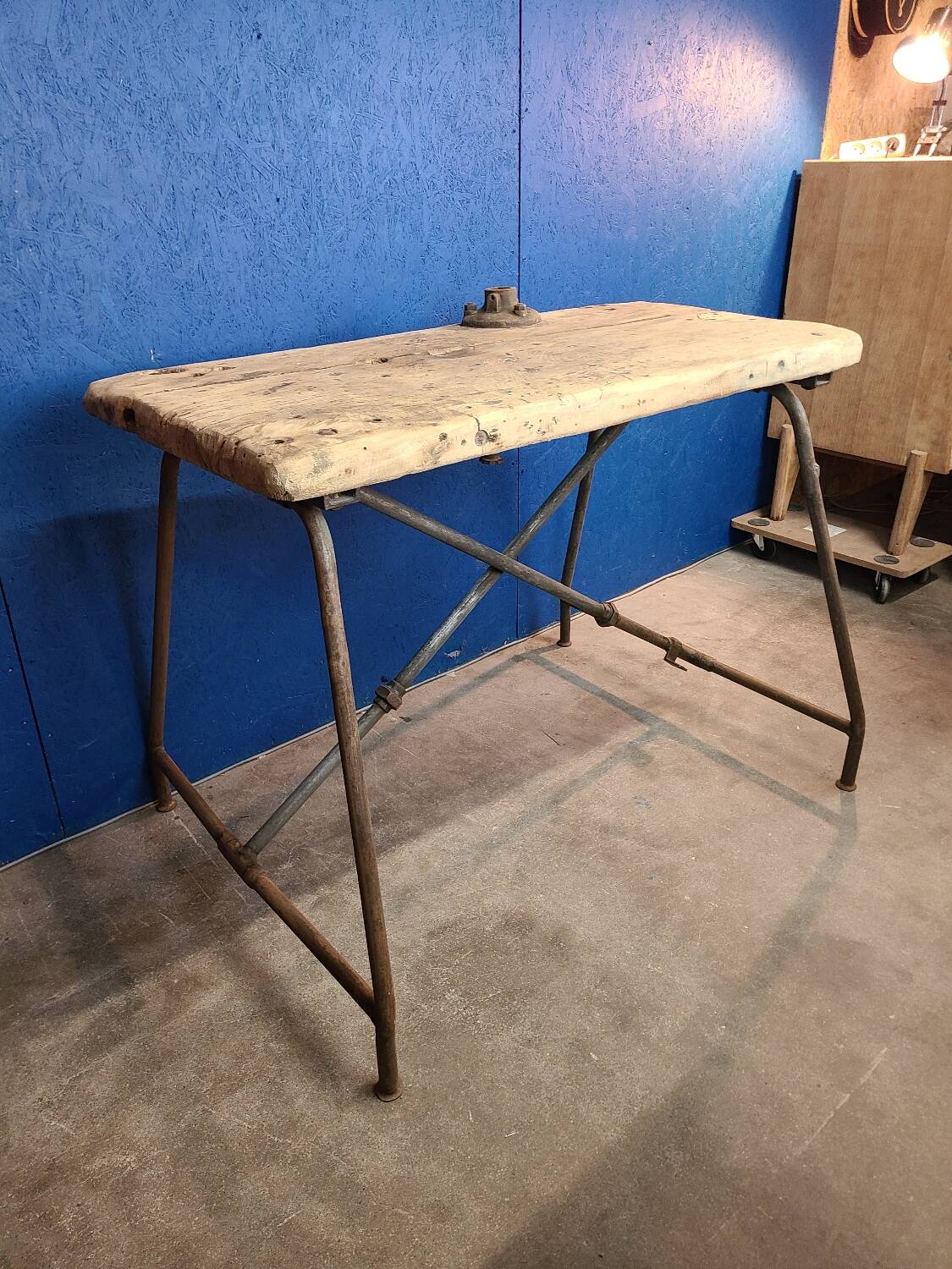 Vintage workbench circa 1930, folding metal leg.
