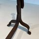 Pair of wrought iron andirons with adjustable supports and tripod feet.