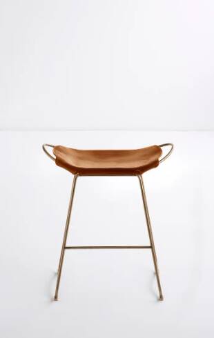 Contemporary kitchen bar stool in aged brass metal and tan leather.