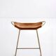 Contemporary kitchen bar stool in aged brass metal and tan leather.
