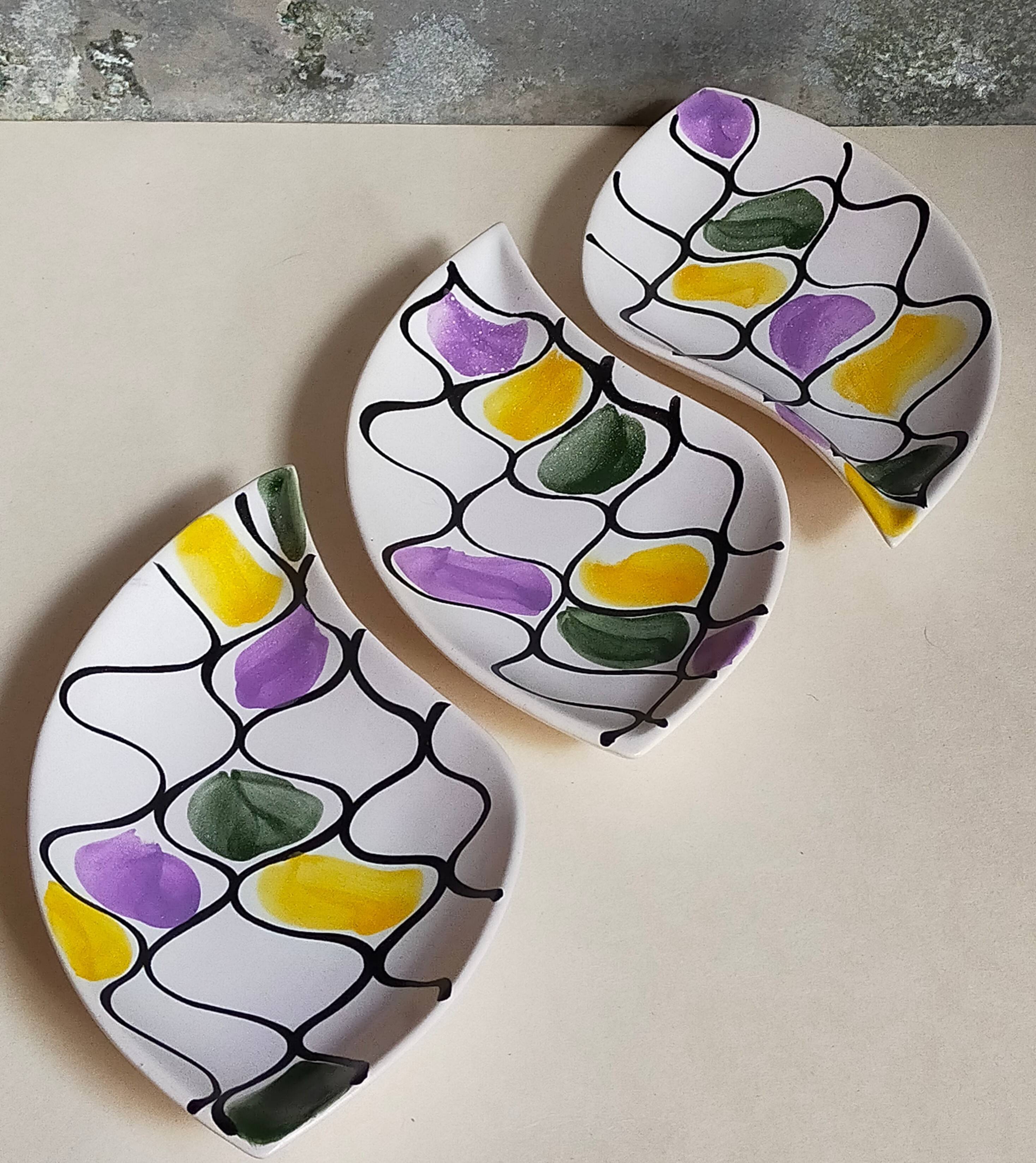 Three vintage free-form ceramic ravine dishes from the 1950s