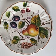 Set of three earthenware plates from Bassano, hand-painted with fruit and flower designs.