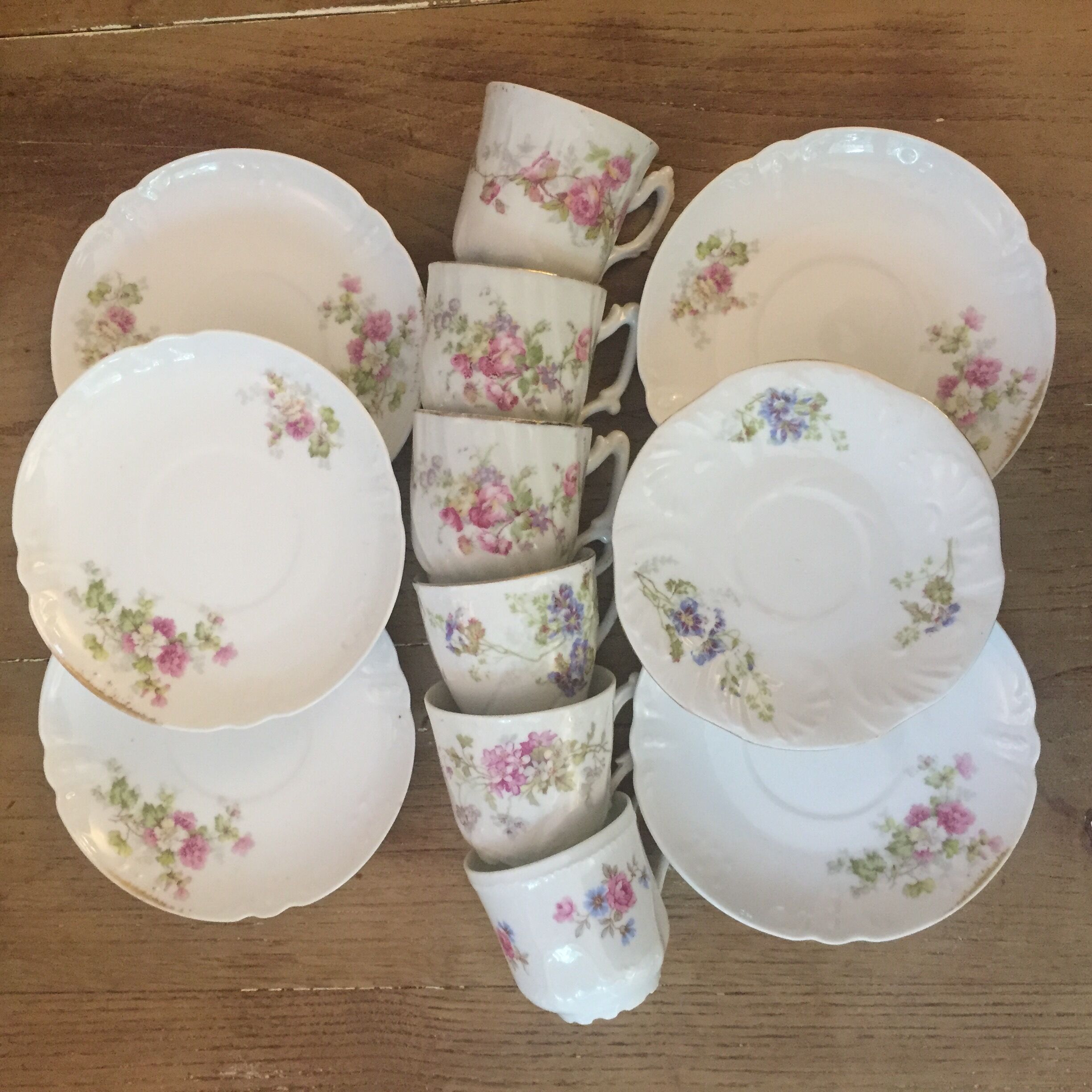 6 antique cups and mismatched saucers