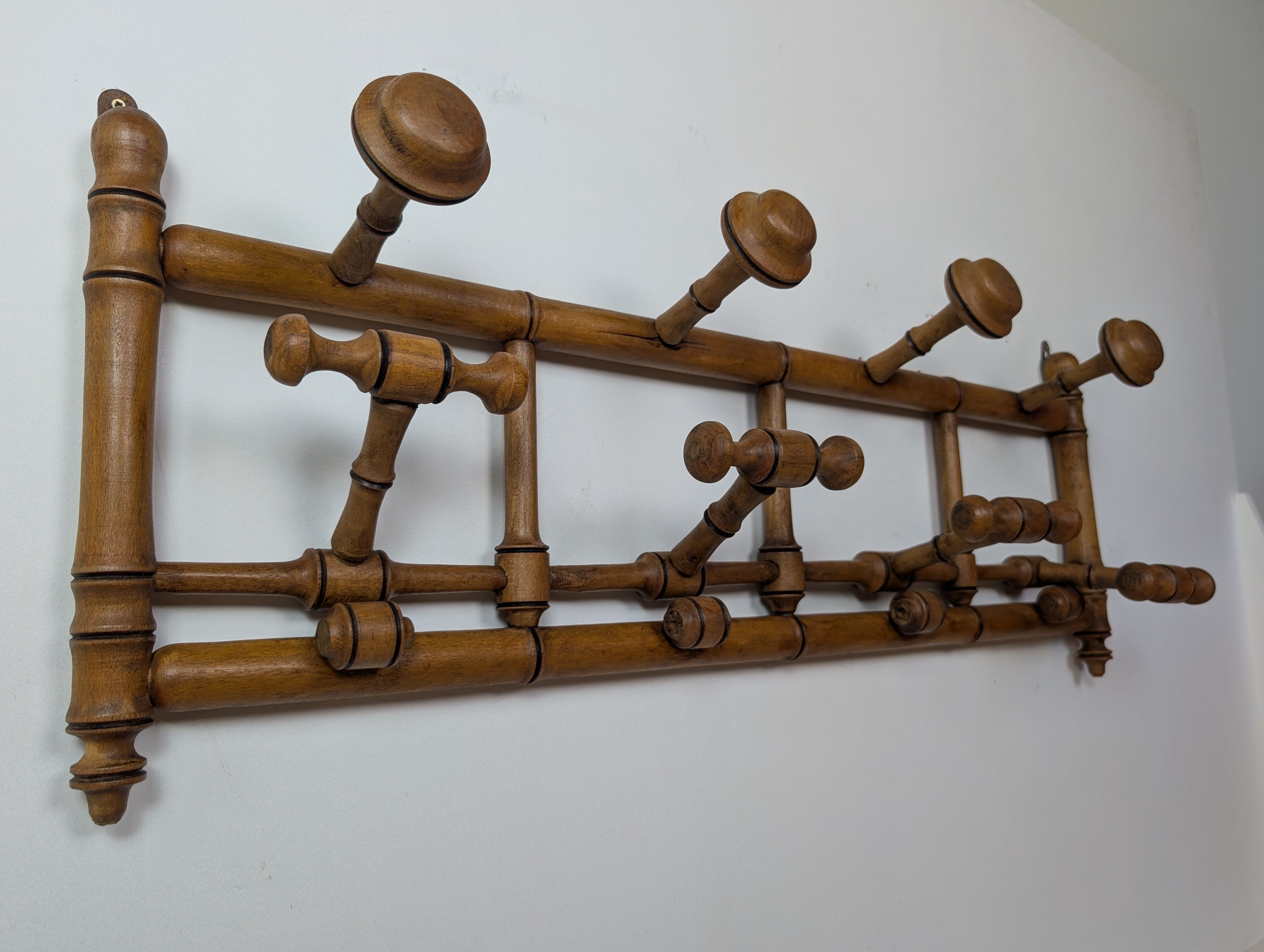 Wall-mounted coat rack made of turned wood