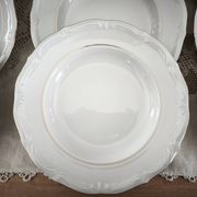 12 deep plates in porcelain with double gold trim.