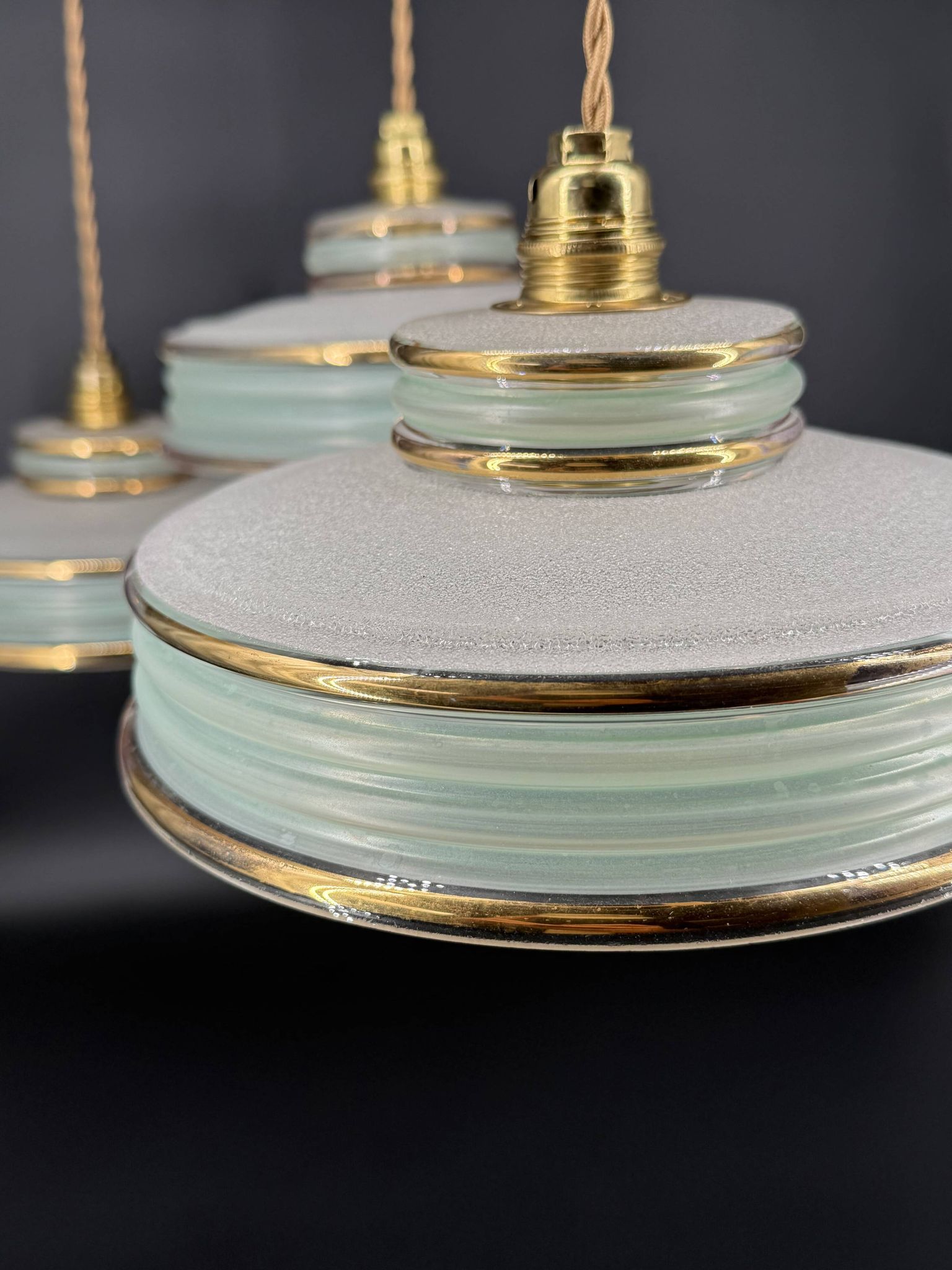 Set of 4 Art Deco pendant lights in frosted water green and gold.