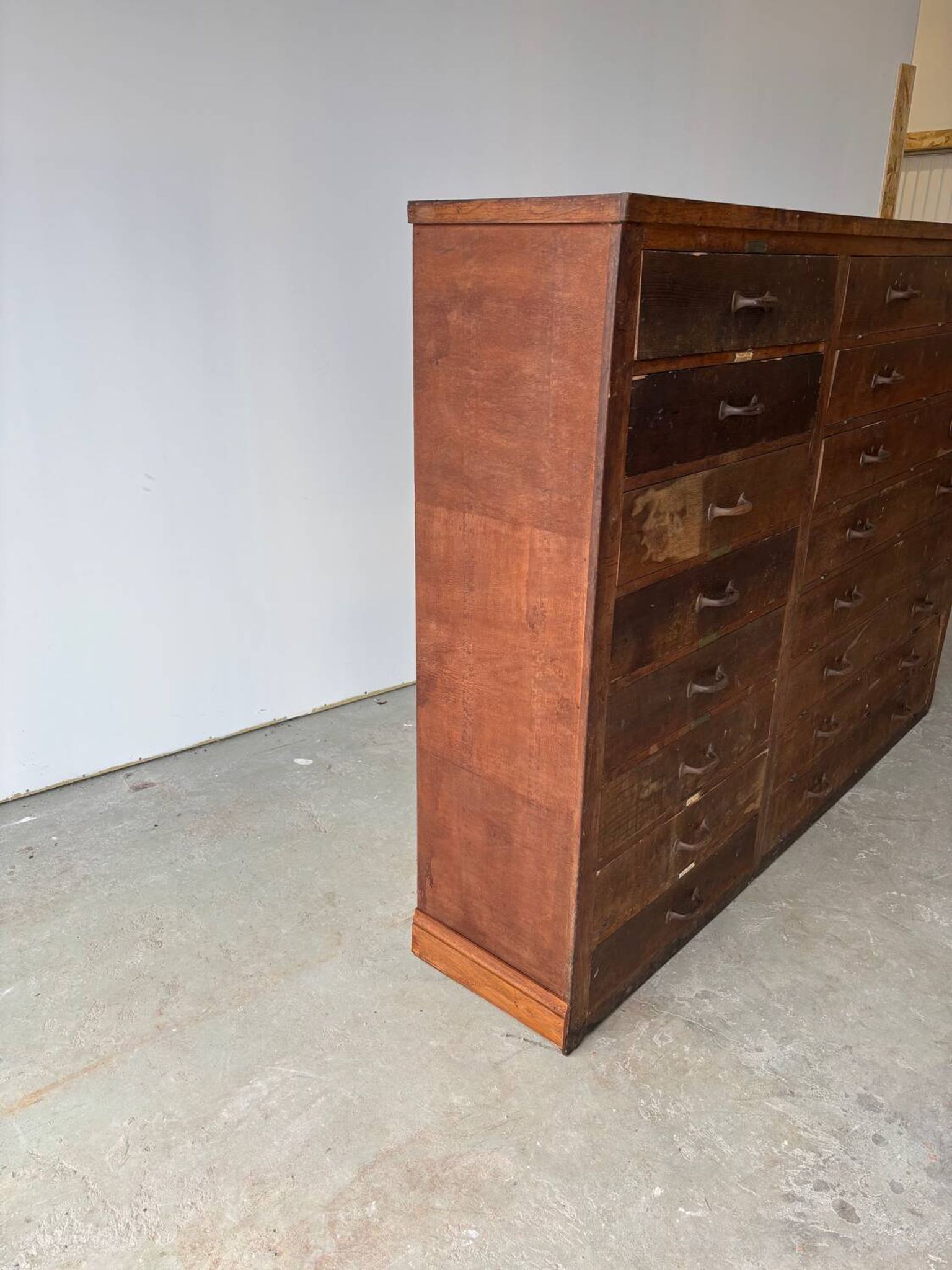 Large wooden workshop cabinet with 16 drawers, antique from the early 1900s.