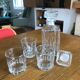 Mismatched decanter and whiskey glasses
