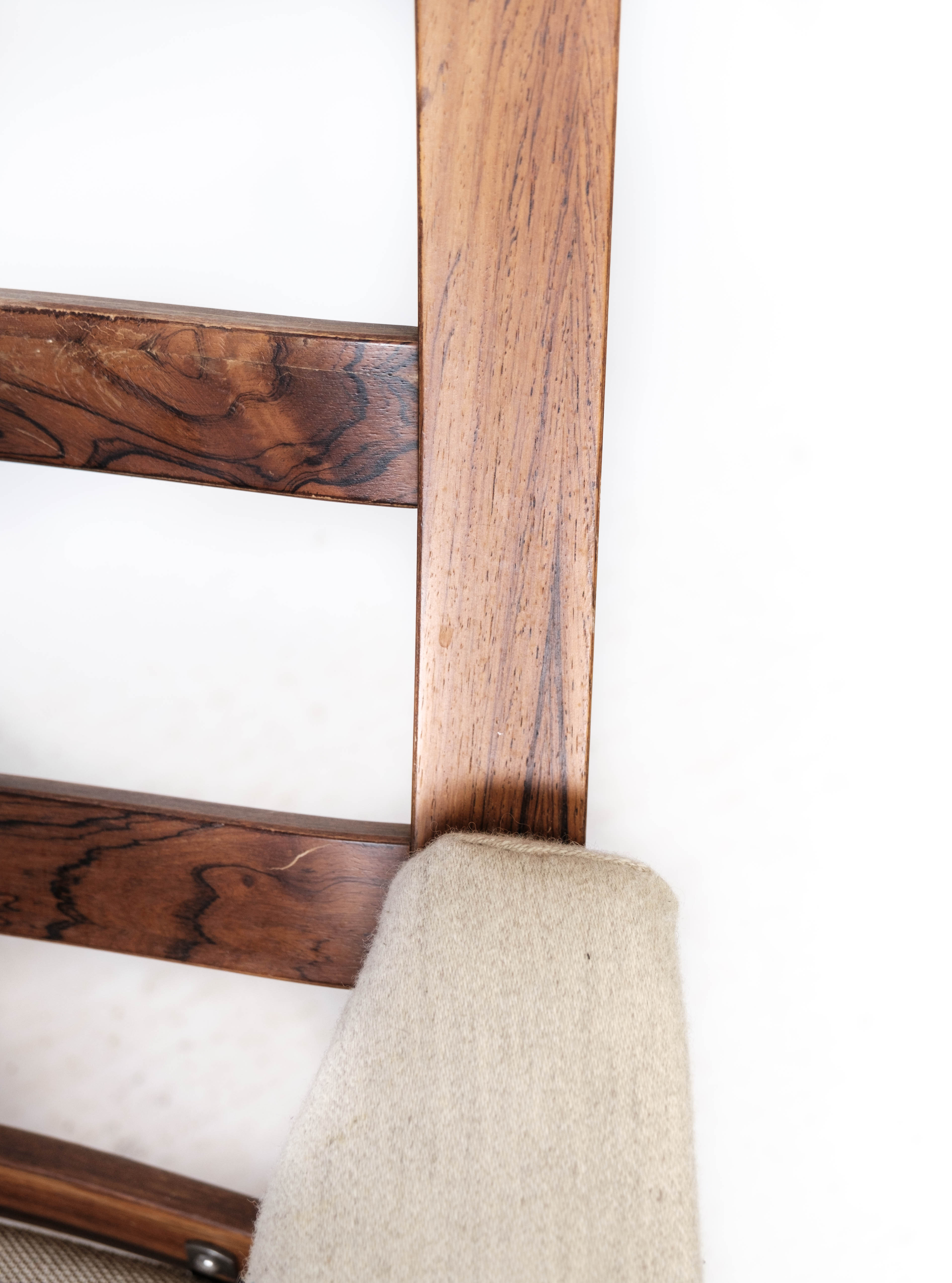 Armchair in rosewood and upholstered with light fabric, of Danish design, 1960s