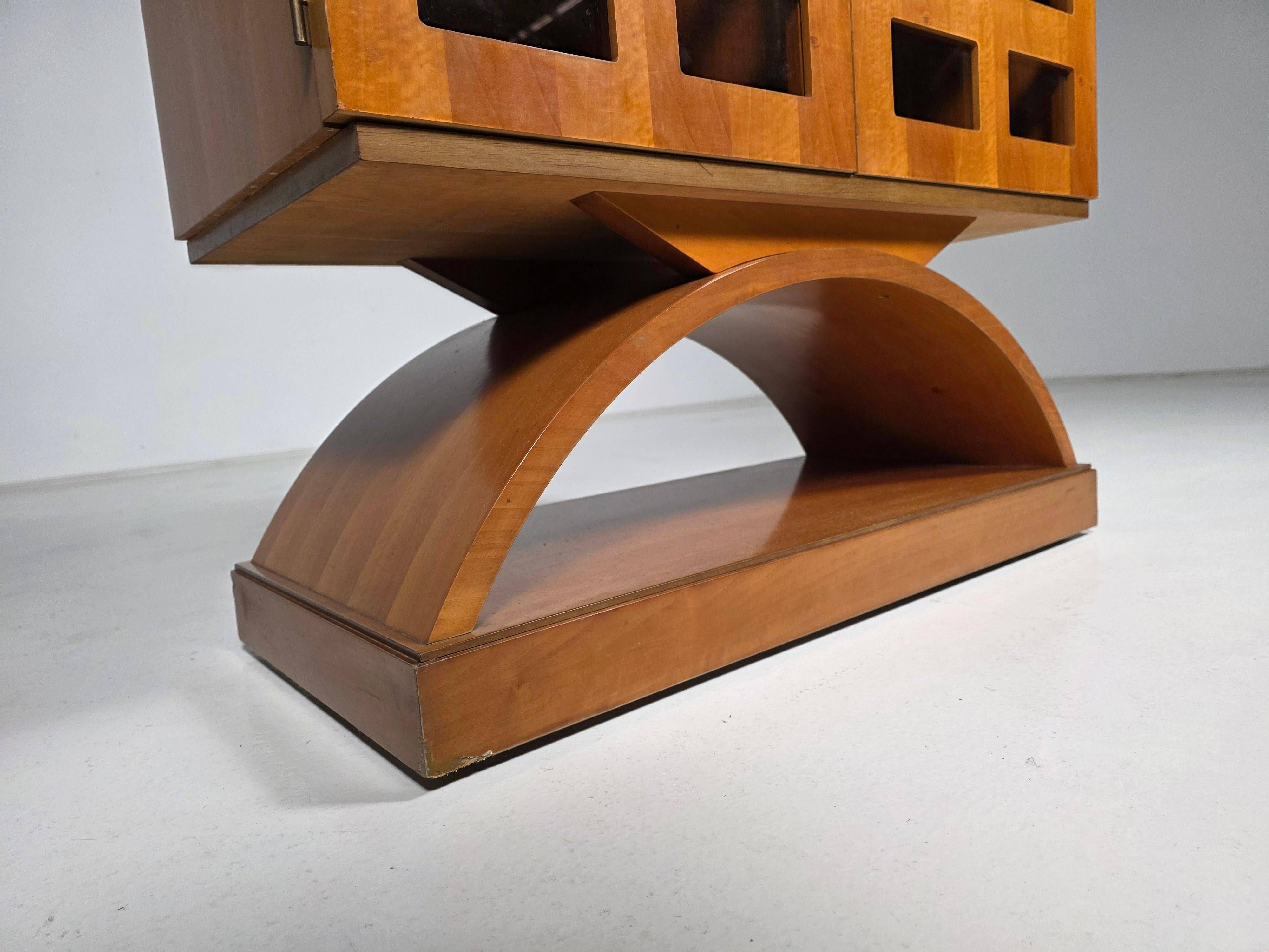 Mid-century modern mobile bar cabinet with sculptural base, 1950s.