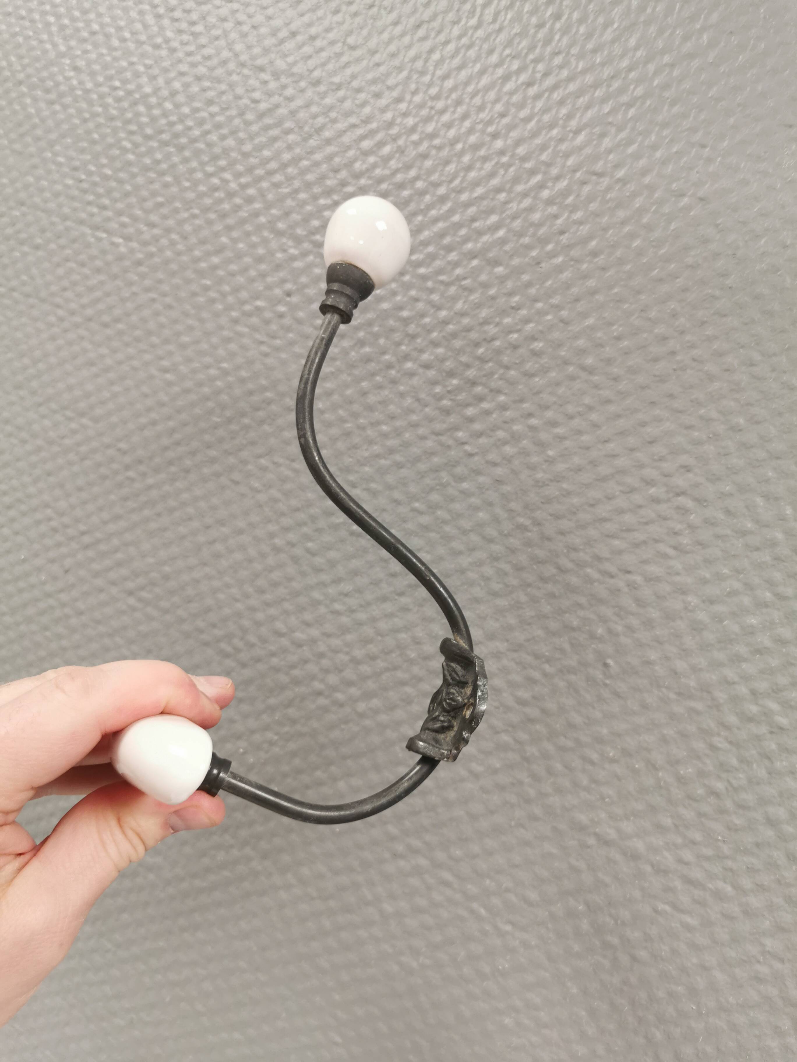 Coat hooks made of galvanized brass and raw white porcelain