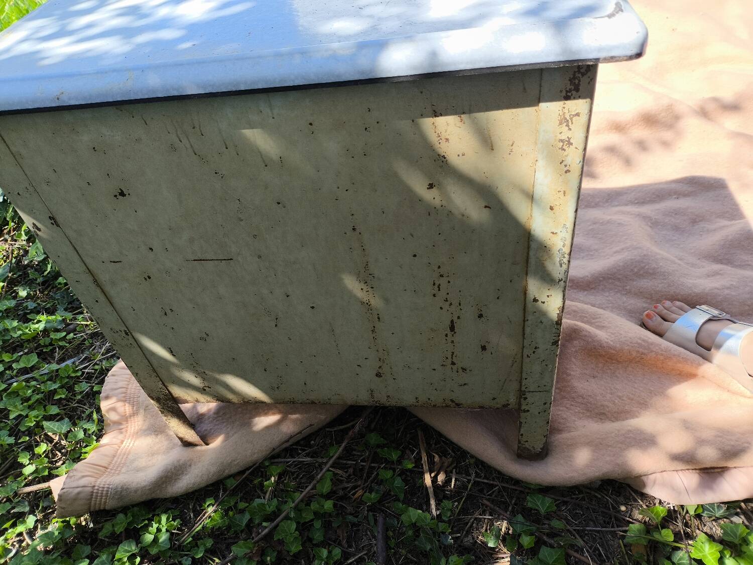 Small white and speckled gray industrial style enameled piece of furniture