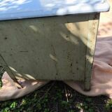 Small white and speckled gray industrial style enameled piece of furniture