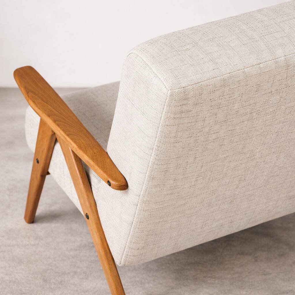 Mid-century modern armchair in solid wood and light beige fabric.