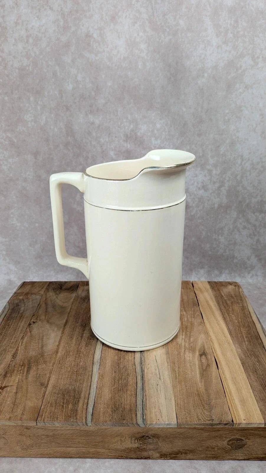 Large antique jug from Sarreguemines with golden trim.