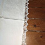 Ancient monogrammed pillowcase adorned with cotton lace