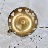 Antique brass rat trap with heart patterns.