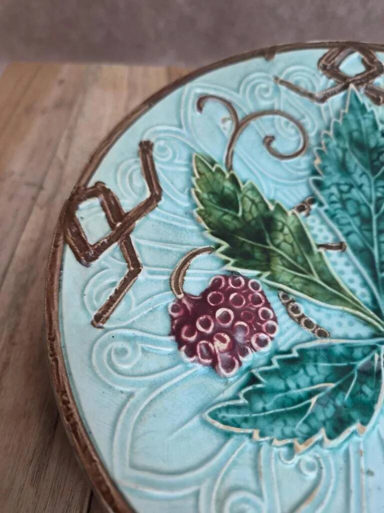 Old small compote dish in turquoise majolica with raised floral decoration.