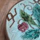 Old small compote dish in turquoise majolica with raised floral decoration.