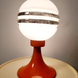 Orange metal and glass table lamp, circa 1960.