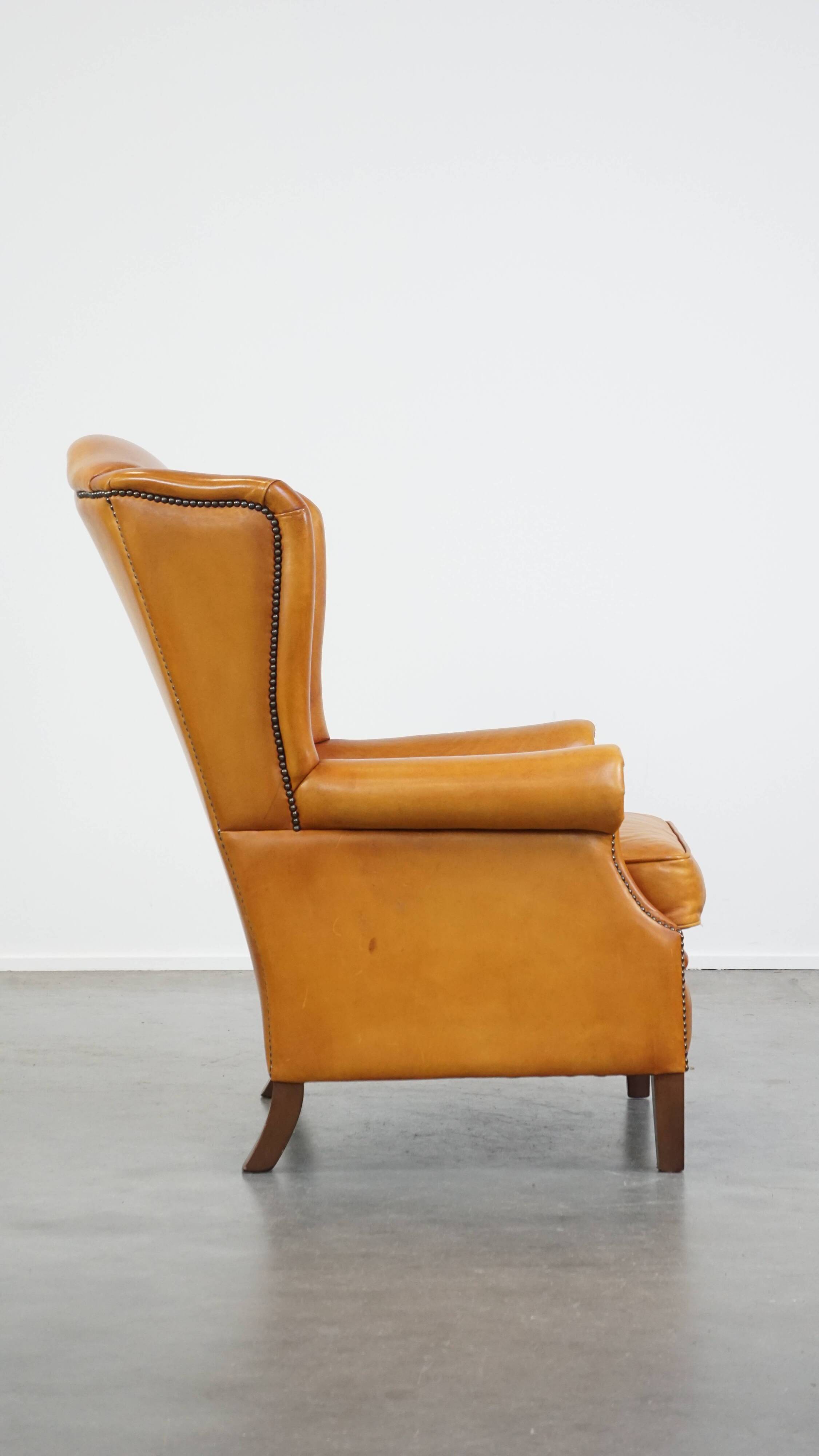 Cow leather wingback chair finished with decorative nails