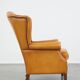 Cow leather wingback chair finished with decorative nails
