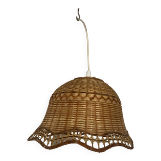 Woven wicker pendant light in the shape of a flower.