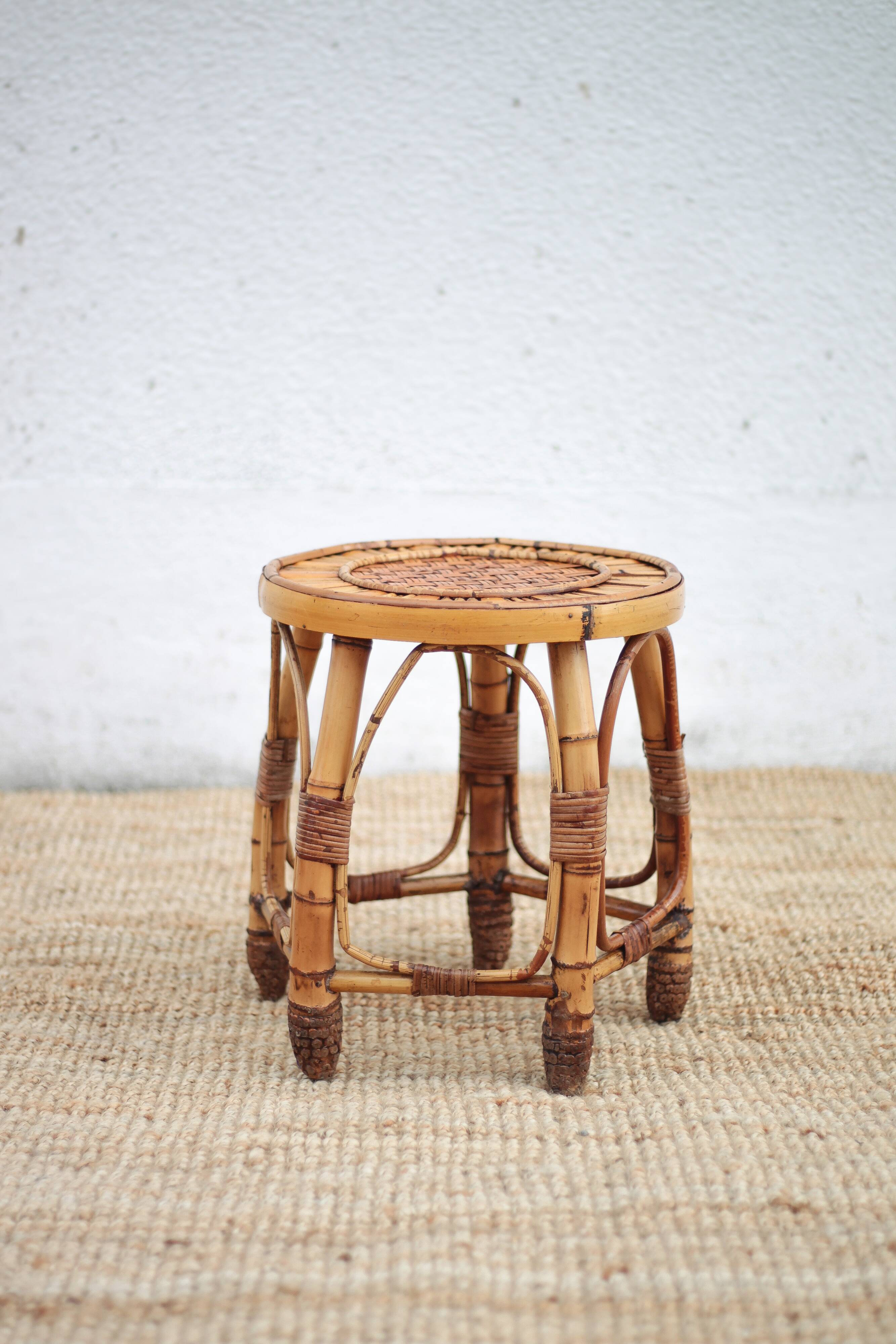 Vintage bamboo stool, woven rattan plant stand, interior decoration.