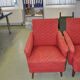 Pair of Mid-Century armchairs in red and brown fabric with dark wooden legs.