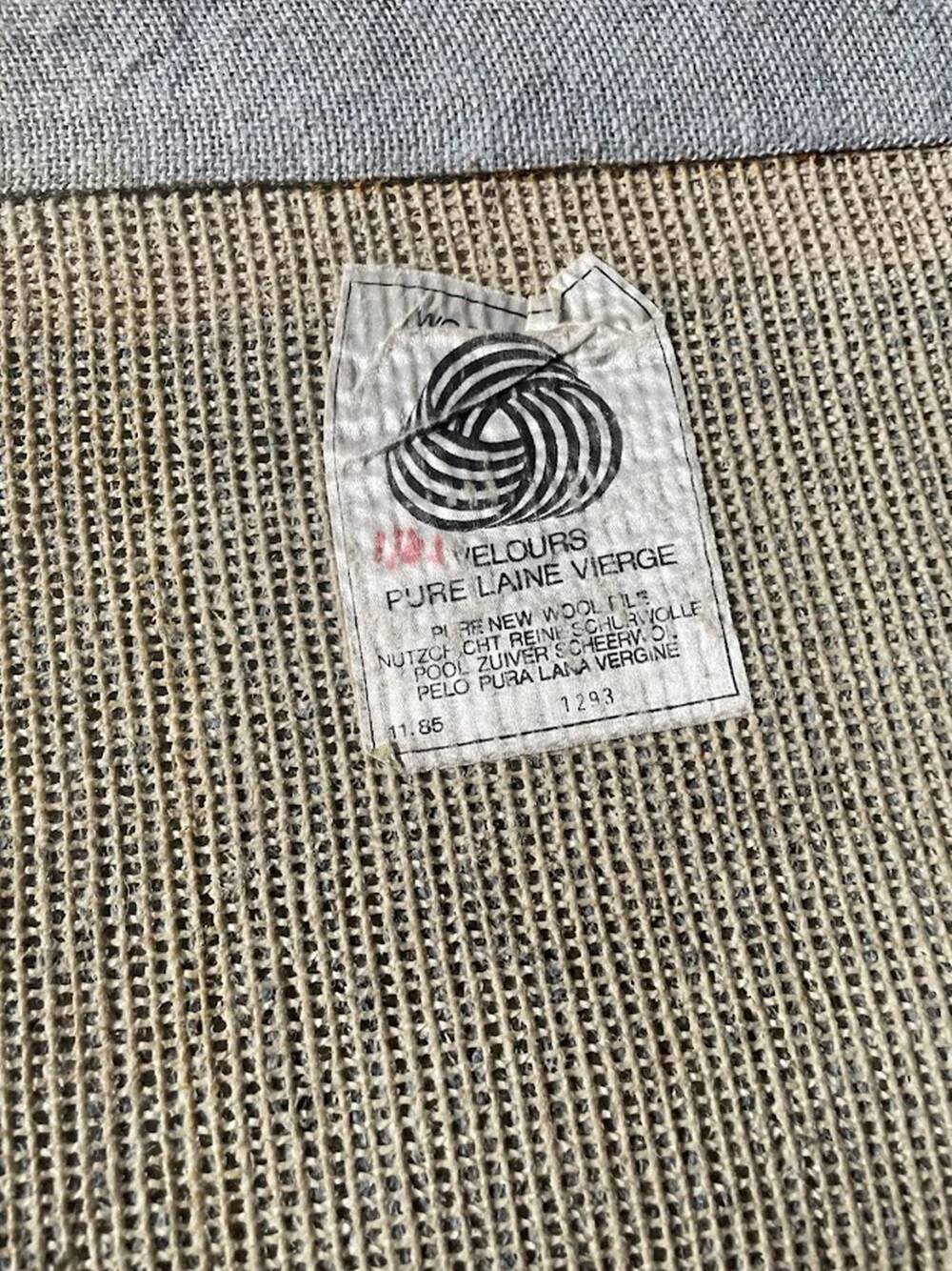 Hand-knotted wool rug by Tisca with a geometric pattern, signed "ILES", France, 1990s.