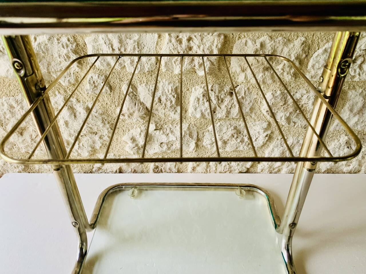 Glass and brass side table with magazine rack, circa 1970's