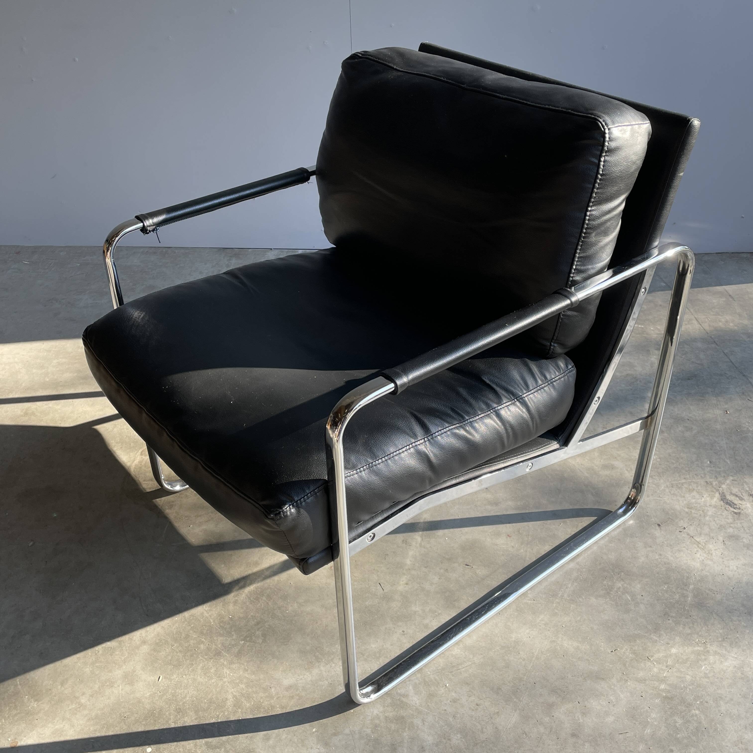 Vintage black leather armchair on metal base, 1980s