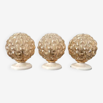 Set of three golden globe wall lights